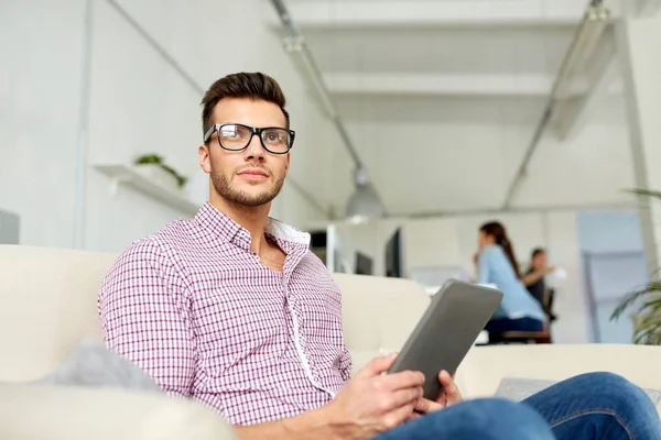 Hombre en gafas con tablet pc trabajando en la oficina — Foto de Stock