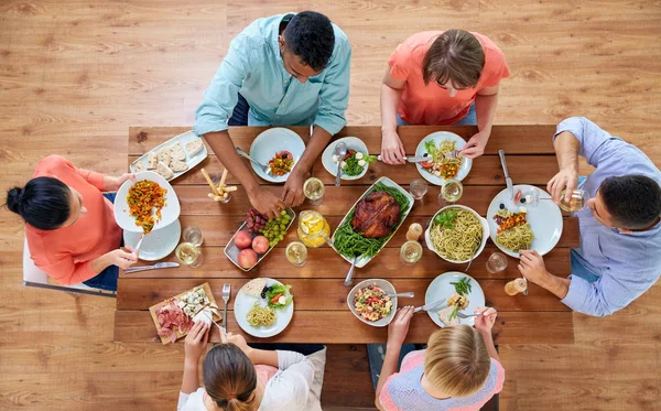 Groupe de personnes mangeant à table avec de la nourriture — Photo