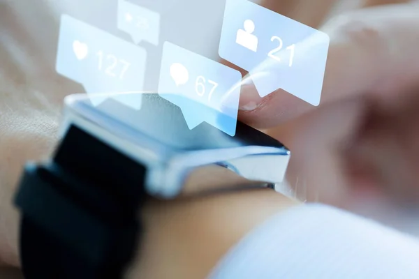Close up of smart watch with social media icons — Stock Photo, Image