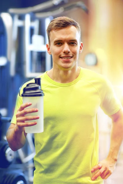 Smiling man with protein shake bottle — Stock Photo, Image