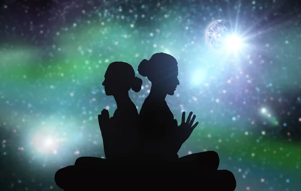 Black silhouette of couple meditating over space — Stock Photo, Image