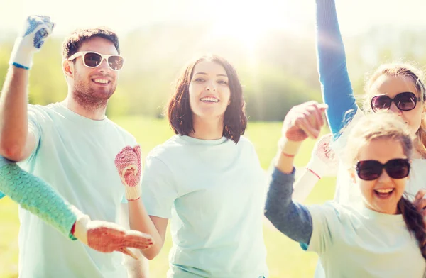 Group of volunteers celebrating success in park — Stock Photo, Image