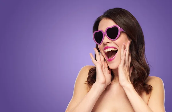 Woman with heart shaped shades over ultra violet — Stock Photo, Image