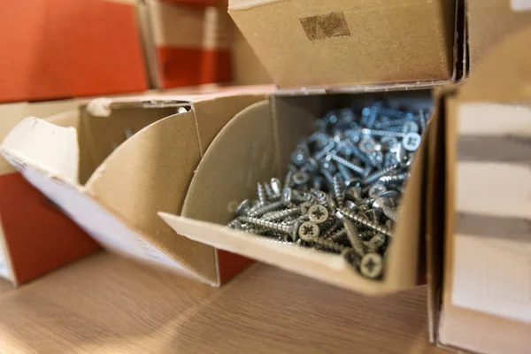 Screws in cardboard boxes at workshop — Stock Photo, Image