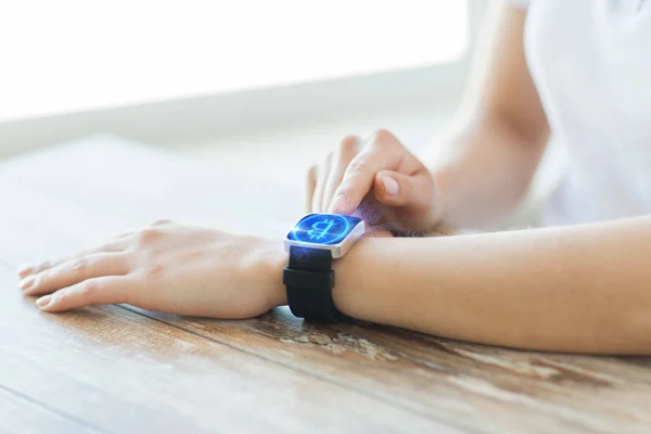 Close up of hands with bitcoin on smart watch — Stock Photo, Image