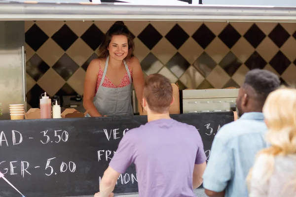 queue of customers and saleswoman at food truck