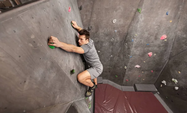 Jovem se exercitando no ginásio de escalada indoor — Fotografia de Stock