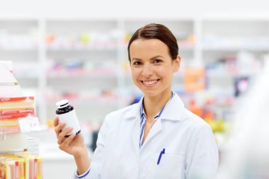 happy female apothecary with drug at pharmacy clipart