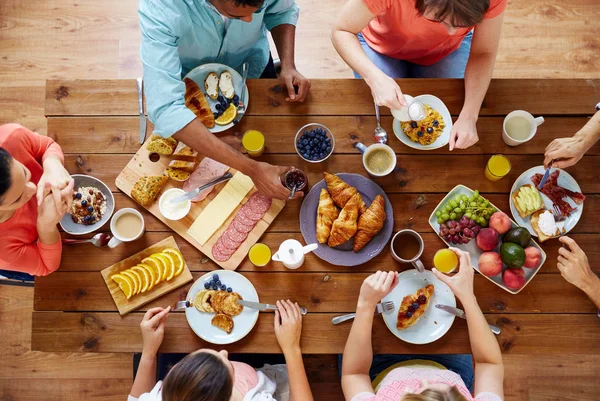 Groupe de personnes prenant le petit déjeuner à table — Photo