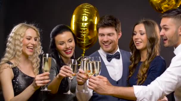 Happy friends clinking champagne glasses at party — Stock Video
