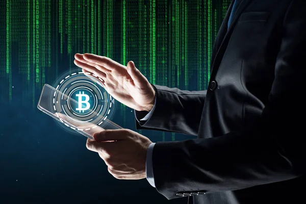 Businessman with tablet pc and bitcoin hologram — Stock Photo, Image