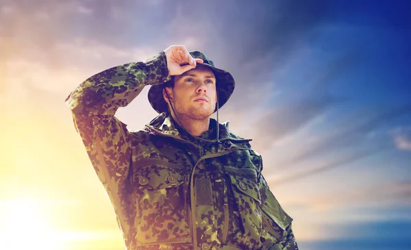 Young soldier in military uniform over sky — Stock Photo, Image