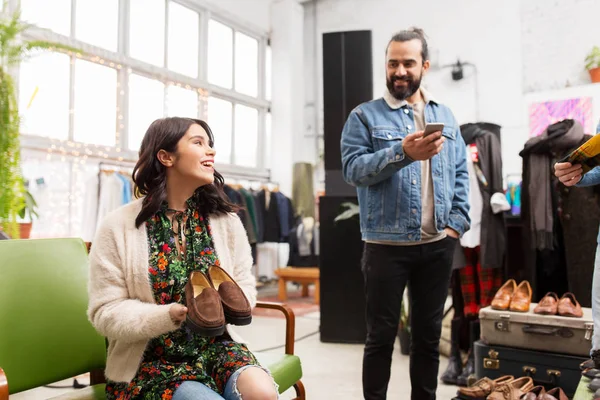 Couple choosing footwear at vintage clothing store — Stock Photo, Image