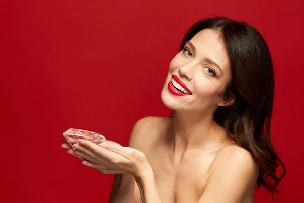 Bella donna con rossetto rosso con diamante in mano — Foto Stock