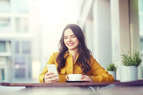 Šťastná žena textilie na smartphone city Café — Stock fotografie