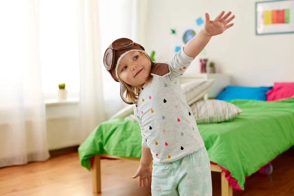 Glückliches kleines Mädchen mit Pilotenhut spielt zu Hause — Stockfoto