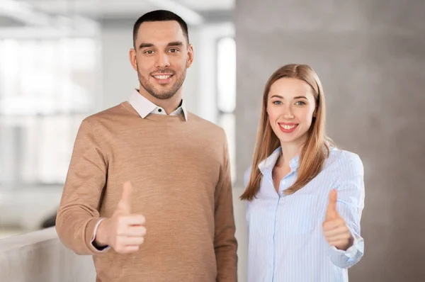 Businesswoman and businessman showing thumbs up — Stock Photo, Image