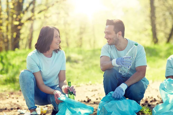 Volunteers with garbage bags cleaning park area — Stock Photo, Image