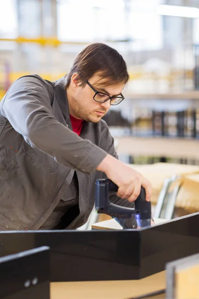 Assembler with screwdriver making furniture — Stock Photo, Image