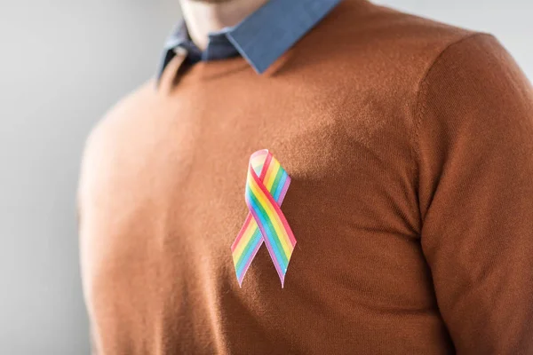 Man with gay pride rainbow awareness ribbon — Stock Photo, Image