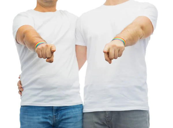 Couple with gay pride rainbow wristbands — Stock Photo, Image