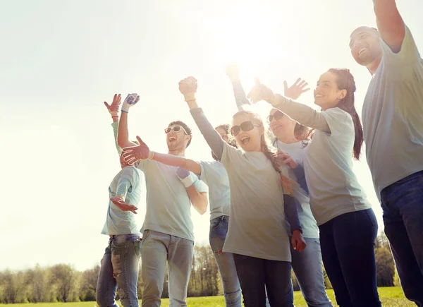 Group of volunteers celebrating success in park — Stock Photo, Image