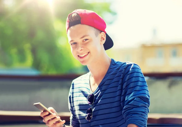 Happy teenage boy with smartphone outdoors — Stock Photo, Image