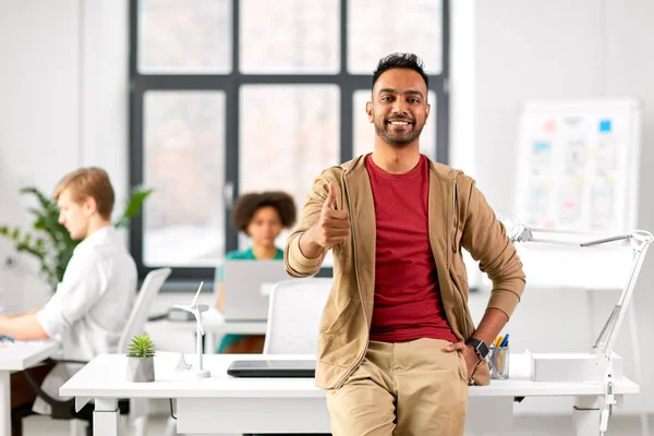 Smiling indian man showing thumbs up at office — Stock Photo, Image