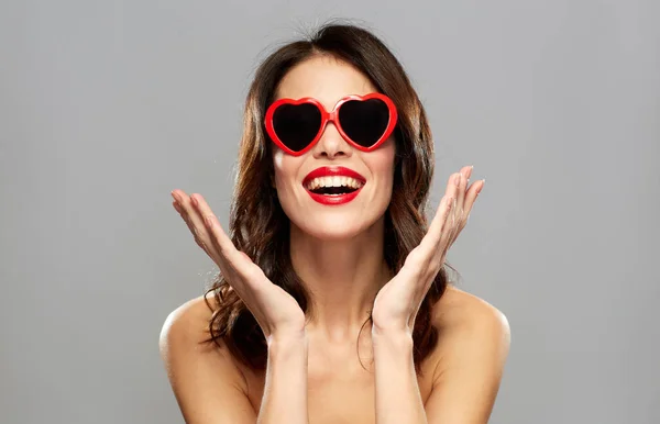 Woman with red lipstick and heart shaped shades — Stock Photo, Image