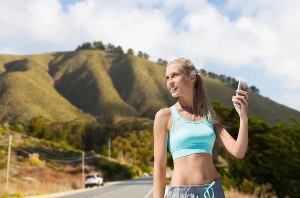 Femme avec smartphone faire du sport sur les collines — Photo