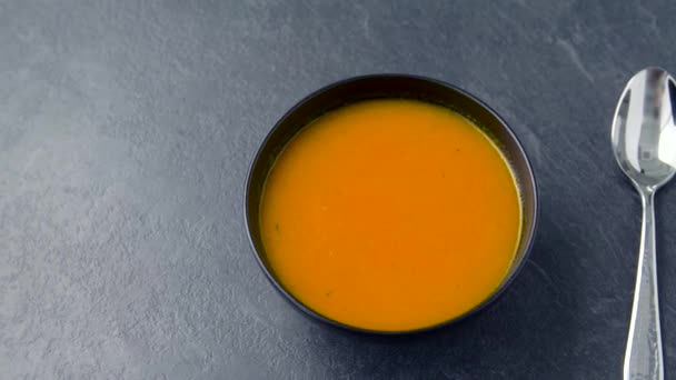 Close up of vegetable pumpkin cream soup in bowl — Stock Video
