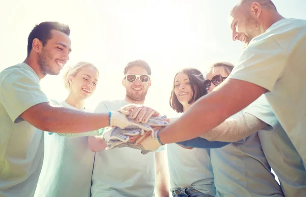 Group of volunteers putting hands on top outdoors — Stock Photo, Image