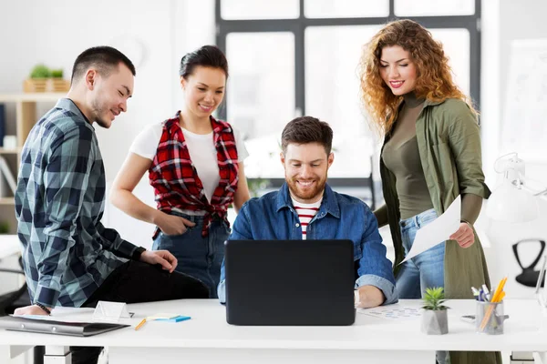 Creative team with laptop working at office — Stock Photo, Image