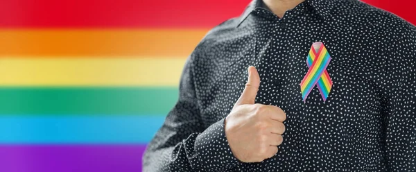 Hombre con gay orgullo arco iris conciencia cinta — Foto de Stock