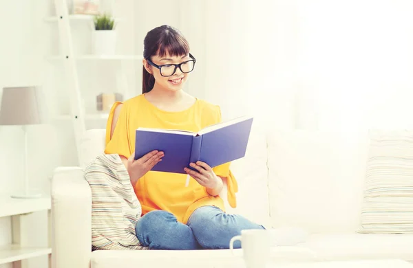 Sorrindo jovem asiático mulher ler livro em casa — Fotografia de Stock