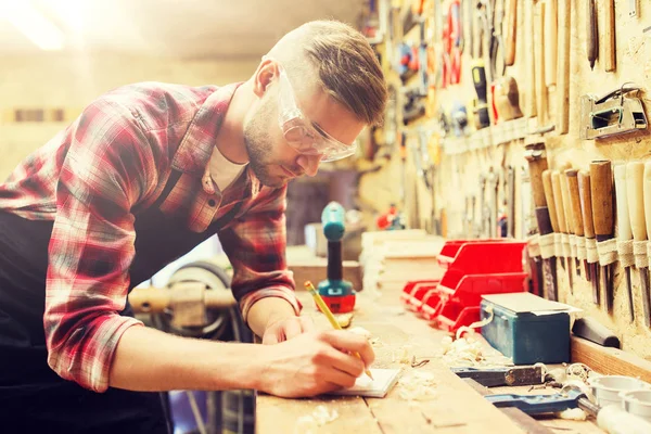 Falegname che scrive a taccuino a workshop — Foto Stock