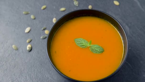 Close up of vegetable pumpkin cream soup in bowl — Stock Video