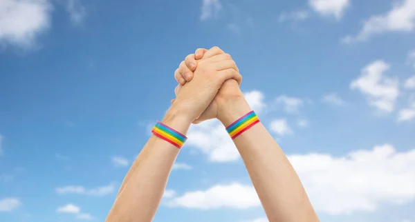 Handen met gay pride-polsbandjes in het winnen van gebaar — Stockfoto