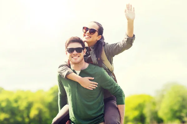 Happy couple with backpacks having fun outdoors — Stock Photo, Image
