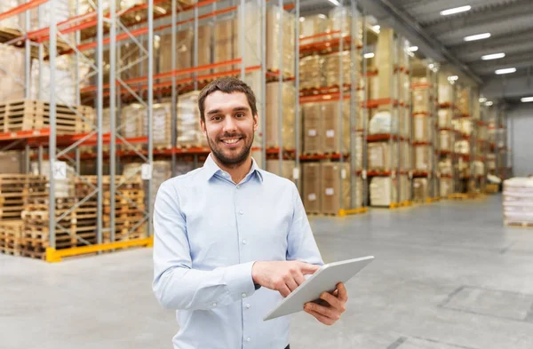 Happy businessman with tablet pc at warehouse — Stock Photo, Image