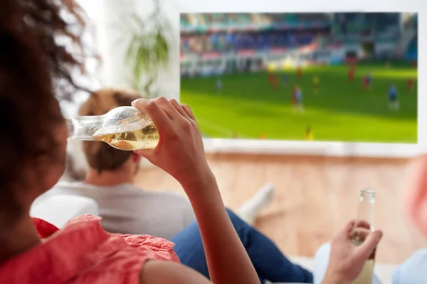 Frau trinkt Bier und schaut Fußballspiel — Stockfoto