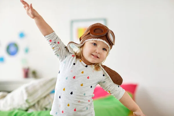 Happy little girl in pilot hat playing at home — Stock Photo, Image