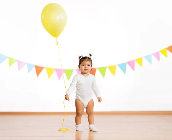 Baby girl with balloons on birthday party — Stock Photo, Image