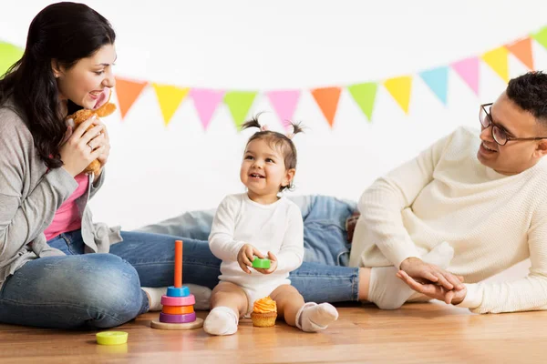 Babymeisje met ouders spelen met speelgoed — Stockfoto