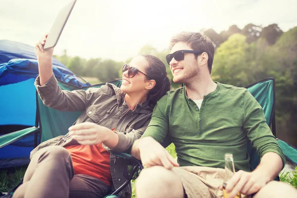 Happy couple with tablet pc at camping tent — Stock Photo, Image
