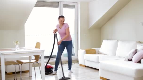 Woman or housewife with vacuum cleaner at home — Stock Video