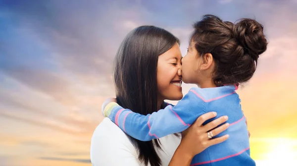 happy mother and daughter hugging and kissing