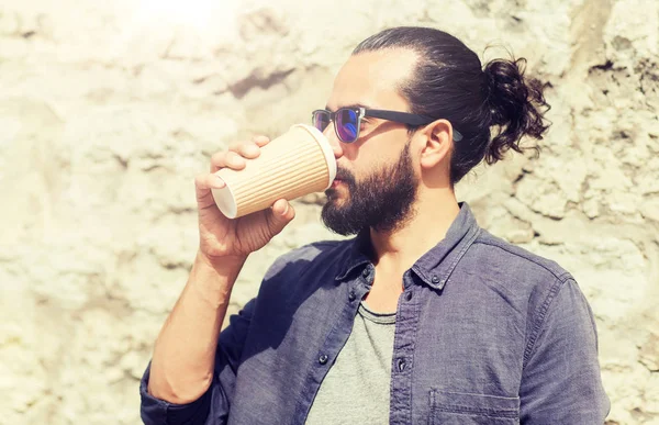 Man drinking coffee from paper cup on street — Stock Photo, Image