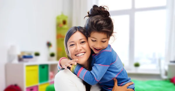 Happy mother and daughter hugging at home — Stock Photo, Image