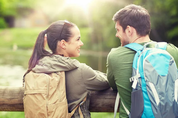 Lachende paar met rugzakken in de natuur — Stockfoto